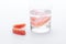 Full Denture in glass of water on white background