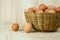 Full of Eggs put in a wicker basket in wooden background.