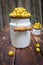 Full enameled can of sweet yellow cherry on a wooden table