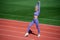 full of energy. athletic lady warming up on stadium running track. female athlete do sport workout. trainer or coach