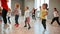 Full of energy. Group of little boys and girls dancing while having choreography class in the dance studio. Female dance