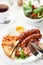 Full English breakfast with bacon, sausage, fried egg and baked beans