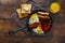 Full English breakfast frying pan wooden table, top view