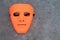 Full Face empty Orange Mask Alien in grey stone background halloween