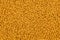 full frame background an seamless texture of small dry orange cat food crockets
