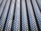 Full Frame Background of Shiny Decorative Perforated Stainless Steel Tubes