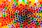 Full frame of a bunch of many plastic drinking straws seen from the top view creating a colorful background