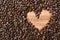 Full frame image of fresh dark roasted coffee beans with love shape copy space