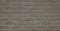 Full frame image of gray decorative brick wall, building exterior. High resolution seamless texture