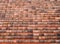 Full frame image of an old clay pantile roof with curves orange tiles in long rows