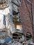 Full frame image of a wrecked collapsing building being demolished with smashed brick walls and rubble