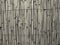 Full frame monochrome sepia cracked faded old bamboo fence background