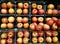 Full frame of red apples grouped and stacked on display shelves