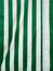 Full frame striped canvas. Vertical green and white striped awning fabric texture. Vertical striped fabric background. Striped