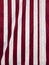 Full frame striped canvas. Vertical red and white striped awning fabric texture. Vertical red and white striped fabric background