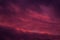 Full frame view heavy sky cloudscape bright pink violet colors