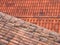 Full frame view of old and new traditional red terracotta roofs with curved overlapping tiles in overlapping lines