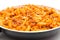 Full frying pan with macaroni bolognesa