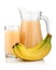 Full glass and jug of banana juice isolated