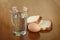 Full glass of water, egg and two slices of bread on scratched table