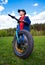 In full growth. A child boy stands in the summer on a meadow with a fatbike bike. Handsome cute boy loves to ride a bike