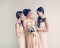In full growth. girl bride with her friends in elegant dresses.
