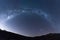 Full half-circle Milky way galaxy star shot across landscape