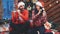 Full HD of a couple dancing, dressed in santa hats and red clothes over wooden background.