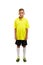 Full height of a cute boy in a yellow t-shirt, black shorts and white knee socks isolated on a white background.