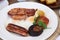 A full Irish breakfast consisting of bacon, egg, sausage, black pudding and grilled tomato.