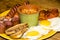 full Irish breakfast high-calorie french bean sausage toast bacon on a wooden background