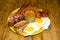 full Irish breakfast high-calorie french bean sausage toast bacon on a wooden background