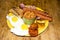 full Irish breakfast high-calorie french bean sausage toast bacon on a wooden background