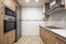 Full kitchen with wooden furniture, appliances and stainless