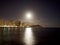 Full Large Moon hangs over Diamond Head Crater, Waikiki hotels, and Marina