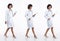 Full length 20s young Asian Doctor Woman wear stethoscope; uniform coat, walking forward right