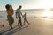 Full length of african american enjoying summer sunset at beach