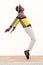 Full length african male dancer standing on his tip toes making a cool dance pose