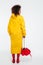 Full length back view image of african woman in raincoat