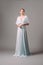 Full-length blue bridesmaid dress with flutter sleeves. Effortless festive summer look.