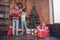 Full length body size back view photo couple hanging festive wreath on wall before xmas