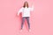 Full length body size girl wearing hoodie sunglass smiling dancing like robot isolated pastel pink color background