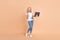 Full length body size photo blonde woman gesturing like winner keeping laptop isolated pastel beige color background