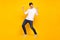 Full length body size photo brunet guy in casual outfit chilling on holidays dancing overjoyed isolated vibrant yellow