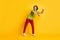 Full length body size photo of careless playful man wearing red trousers dancing laughing isolated on vivid yellow color