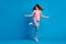 Full length body size photo of cheerful smiling girl dancing standing tiptoes throwing hair isolated on bright blue