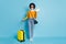 Full length body size photo of girl keeping documents luggage in airport ready to travel isolated on vibrant blue color