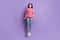 Full length body size photo of jumping high careless childish girl smiling isolated on vibrant violet color background