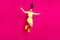 Full length body size photo of jumping high shouting energetic sporty girl laughing isolated on vibrant pink color