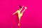 Full length body size photo of jumping high sportswoman shouting loudly keeping leg up isolated on bright pink color